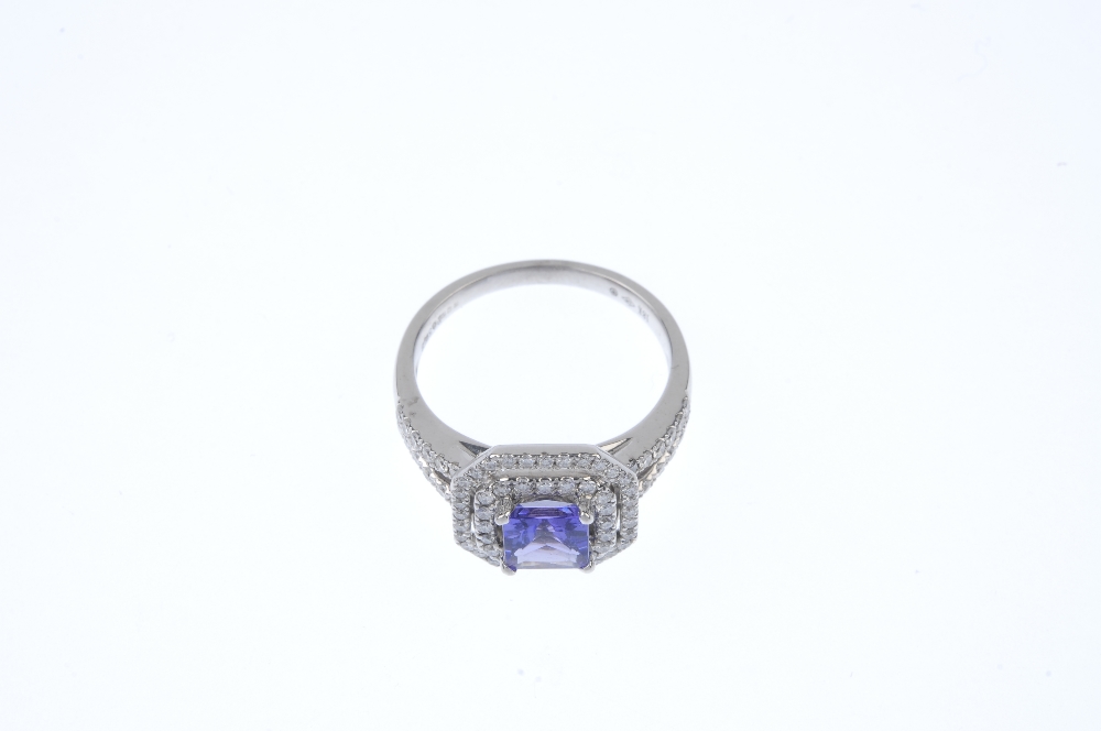 An 18ct gold tanzanite and diamond cluster ring. The square-shape tanzanite, within a brilliant- - Image 2 of 4