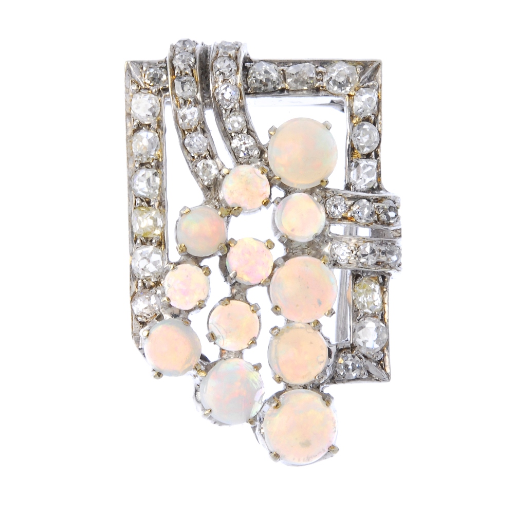 An early 20th century opal and diamond brooch. The circular opal cabochon spray, within an old-cut