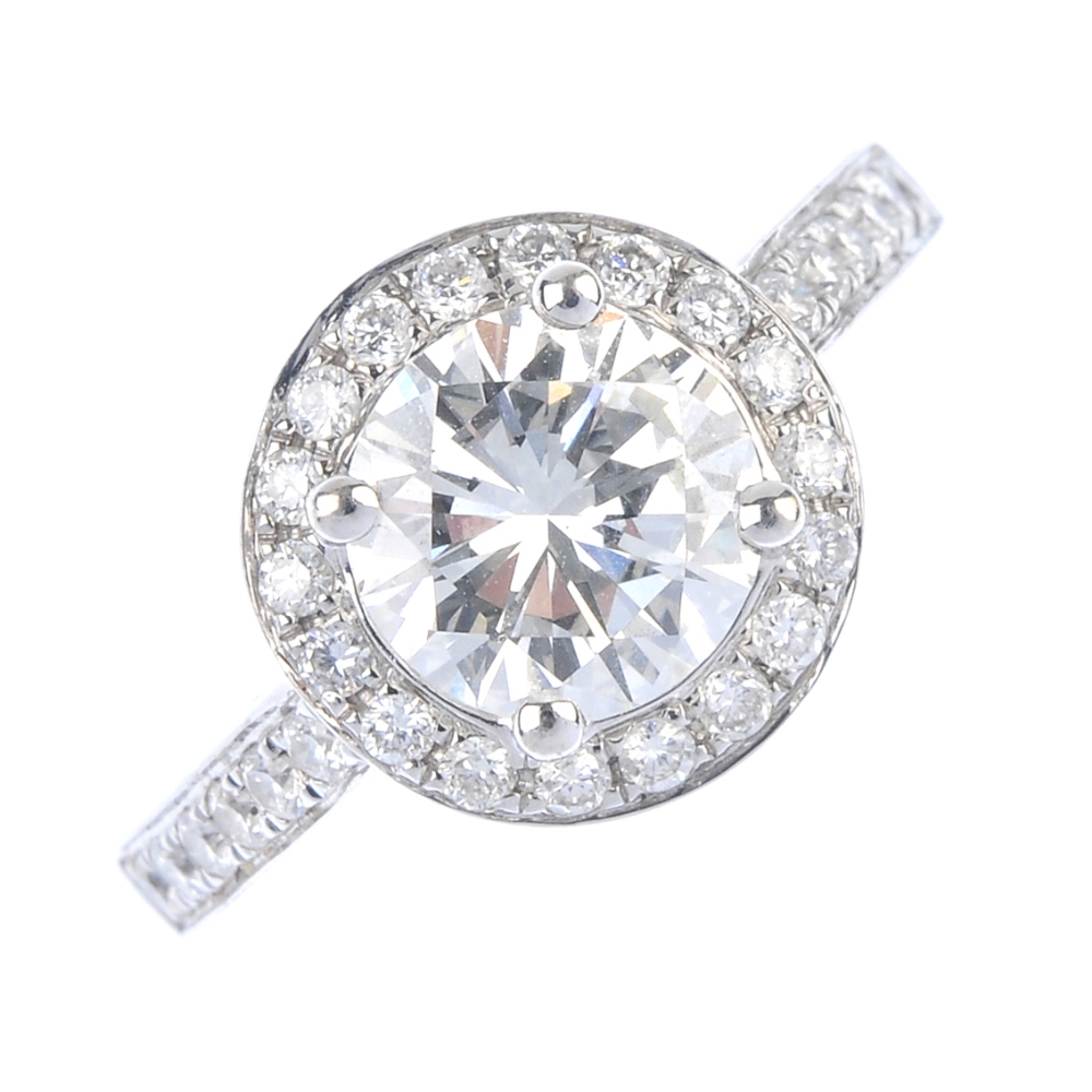 An 18ct gold diamond cluster ring. The brilliant-cut diamond, weighing 1.46cts, to the similarly-cut