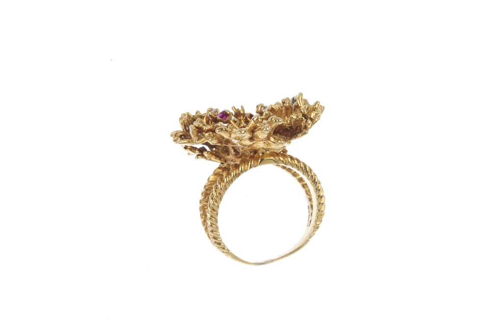 An 18ct gold diamond and ruby dress ring. Of abstract design, the textured foliate panel, with - Image 4 of 4