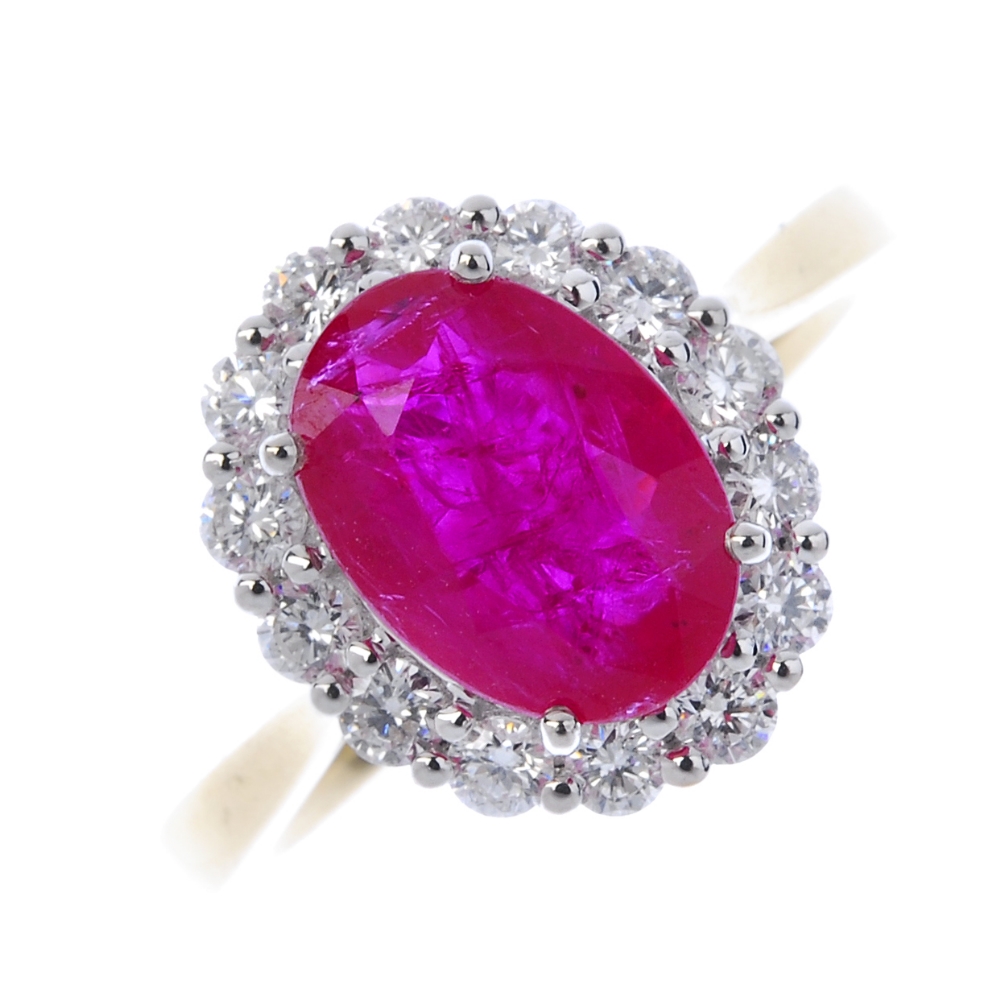 * A ruby and diamond cluster ring. The oval-shape ruby, within a brilliant-cut diamond surround,