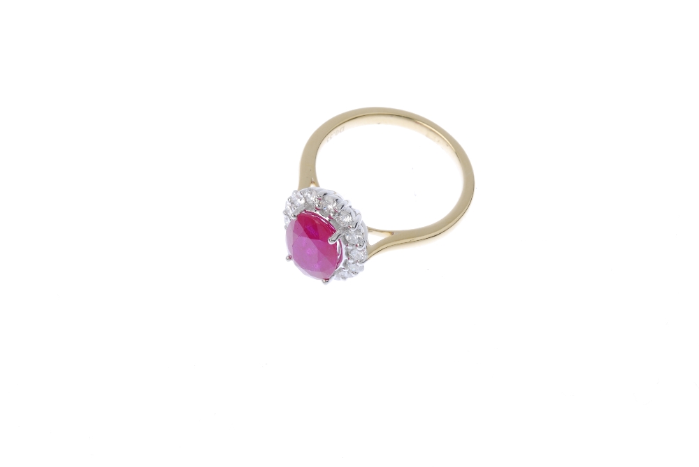 * A ruby and diamond cluster ring. The oval-shape ruby, within a brilliant-cut diamond surround, - Image 2 of 4