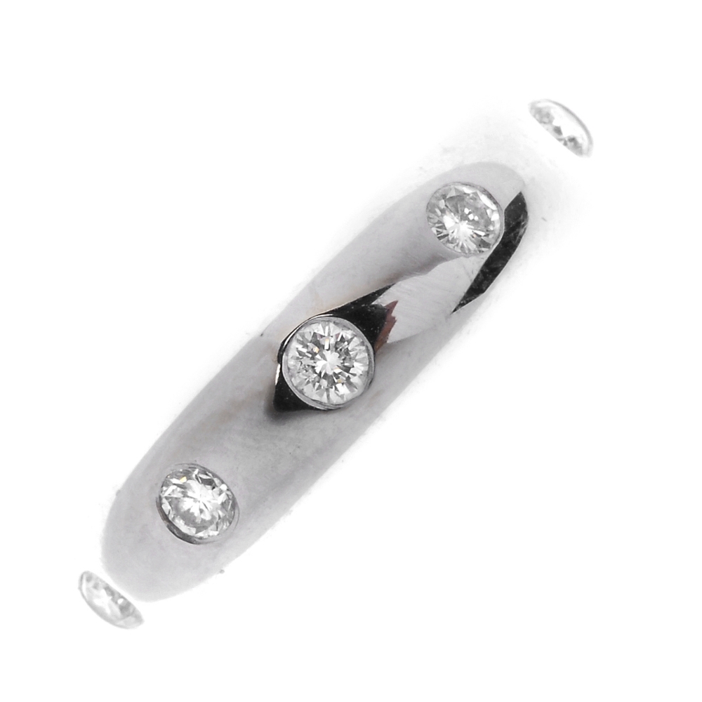 A diamond band ring. Designed as five brilliant-cut diamonds, inset to the plain band. Estimated