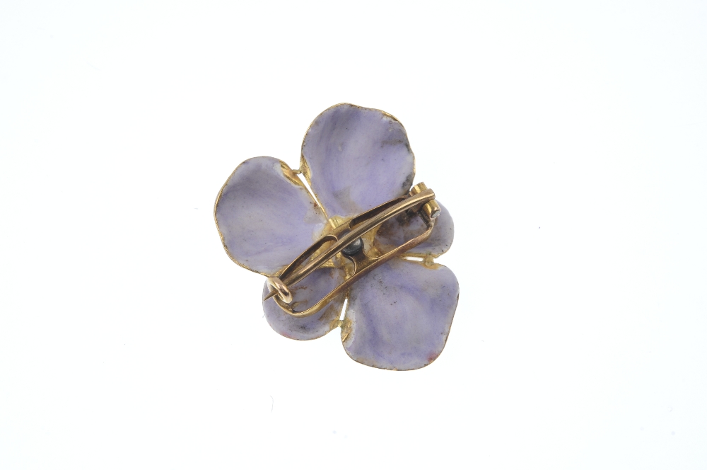 An early 20th century 18ct gold diamond and enamel viola brooch. The old-cut diamond, within a - Image 2 of 2