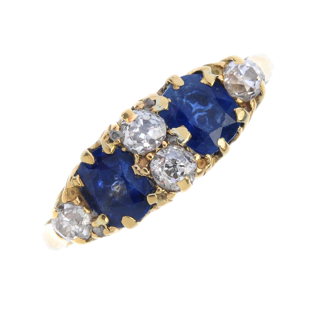 An early 20th century 18ct gold sapphire and diamond dress ring. The two oval-shape sapphires,