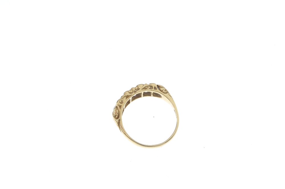 An 18ct gold diamond five-stone ring. The graduated old-cut diamond line, to the scrolling gallery - Image 4 of 4