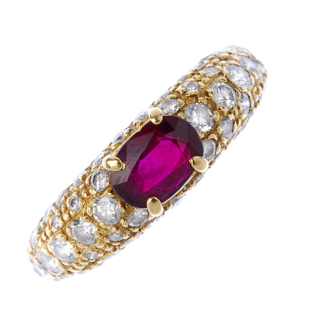 CARTIER - a ruby and diamond dress ring. The oval-shape ruby, to the pave-set diamond sides and