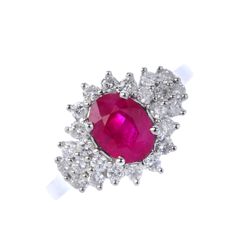 An 18ct gold glass-filled ruby and diamond dress ring.  Of marquise- shape outline, The oval-shape