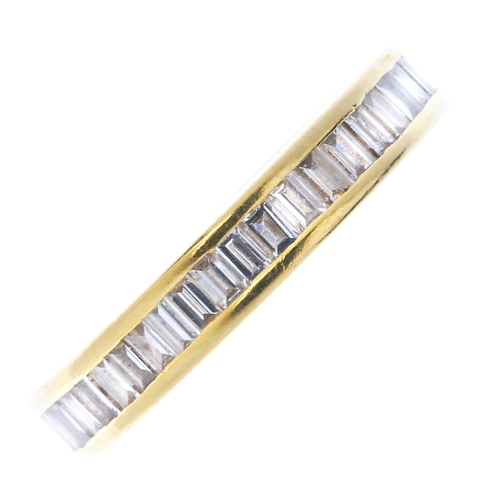 An 18ct gold diamond full-circle eternity ring. The rectangular-shape diamonds, within a chanel-