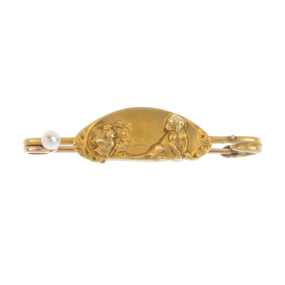 An early 20th century 18ct gold brooch. The oval-shaped panel, depicting three ducklings and a