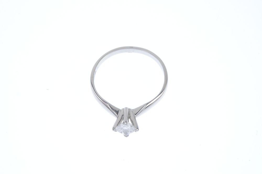 A platinum diamond single-stone ring. The square-shape diamond, weighing 0.59ct, to the plain - Image 2 of 5