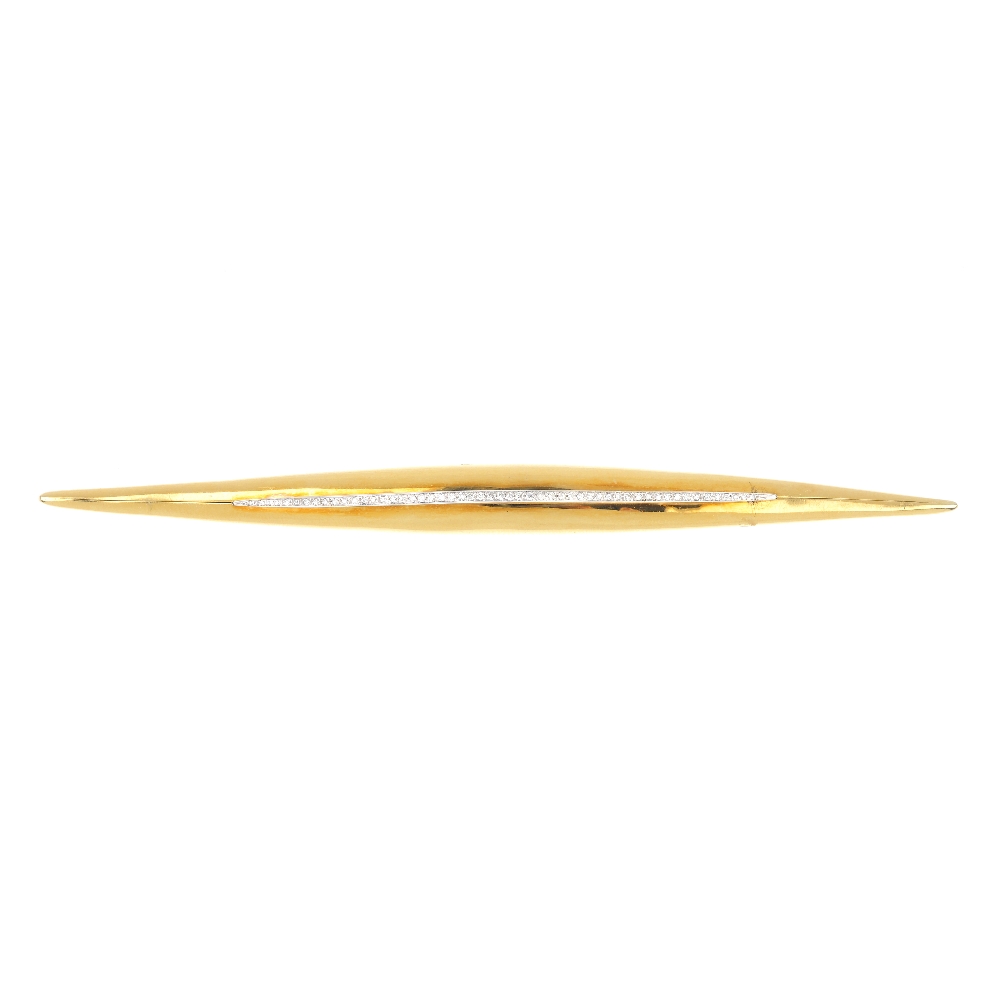 An 18ct gold diamond brooch. Of bi-colour design, the graduated brilliant-cut diamond line, set