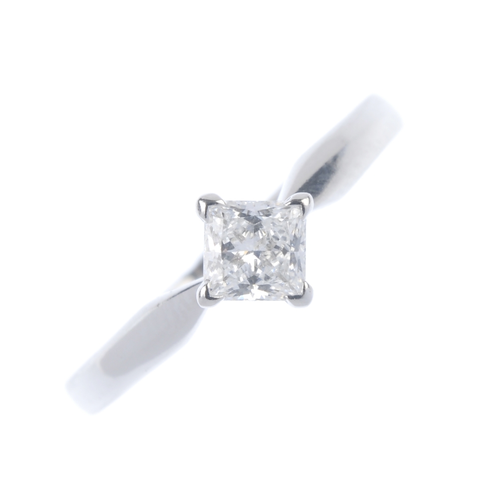 A platinum diamond single-stone ring. The square-shape diamond, weighing 0.59ct, to the plain