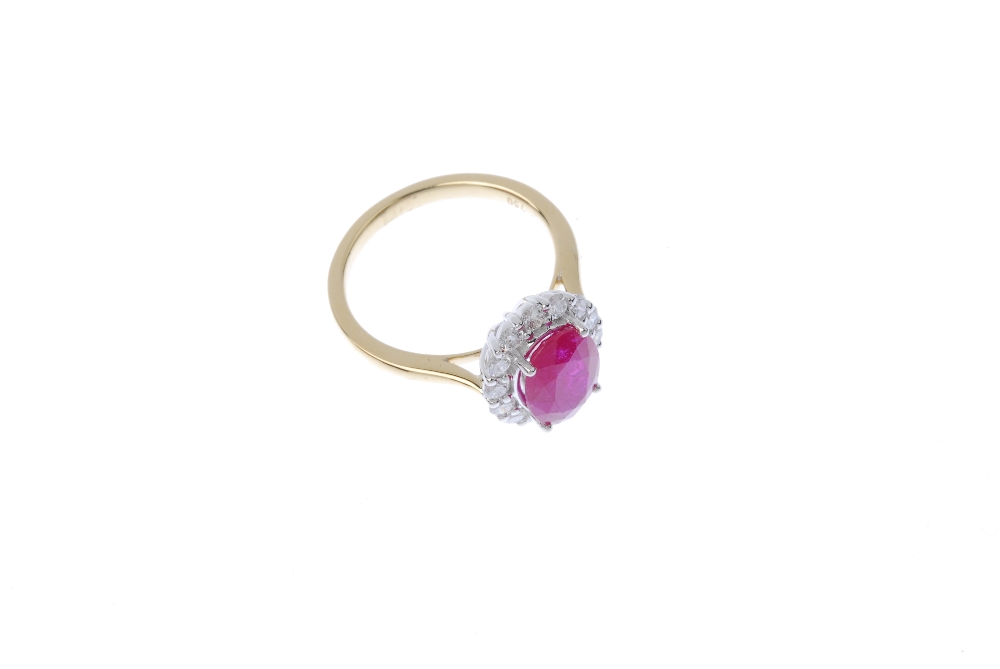 * A ruby and diamond cluster ring. The oval-shape ruby, within a brilliant-cut diamond surround, - Image 3 of 4