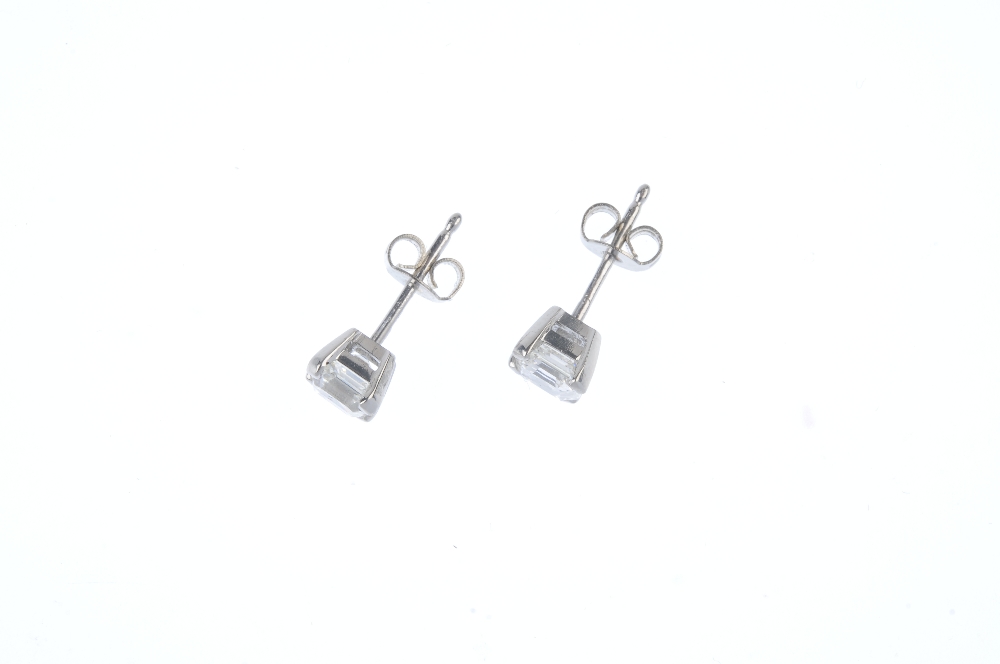 A pair of platinum square-shape diamond ear studs. Accompanied by mini report number 20025968, - Image 2 of 3