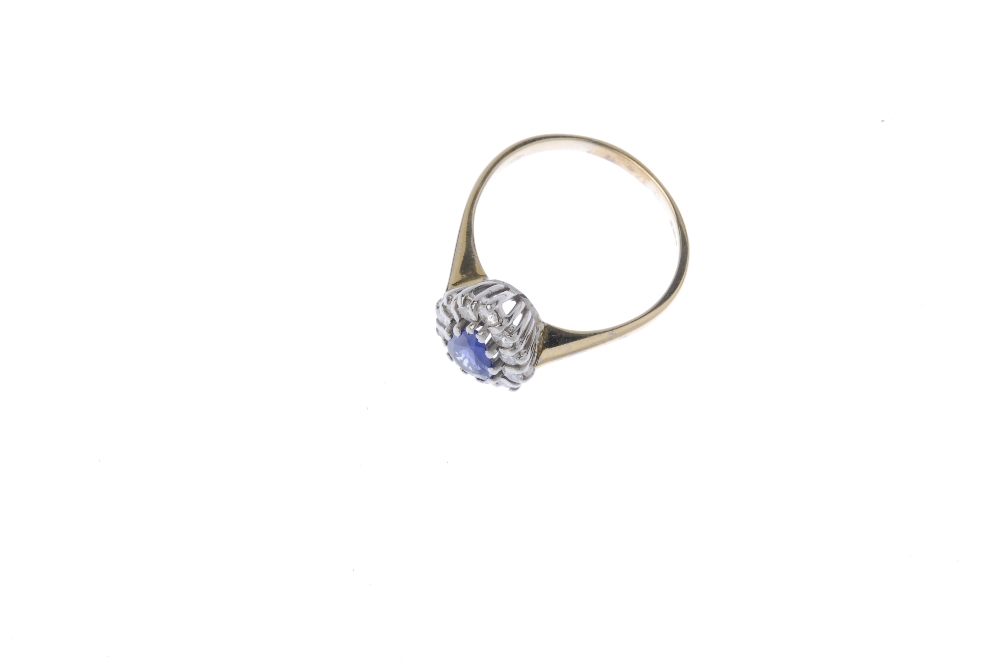 An 18ct gold sapphire diamond cluster ring. The pear-shape sapphire, within a brilliant-cut - Image 2 of 4