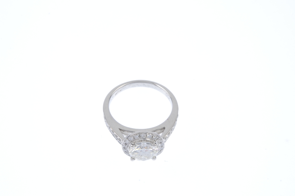 An 18ct gold diamond cluster ring. The brilliant-cut diamond, weighing 1.46cts, to the similarly-cut - Image 2 of 4