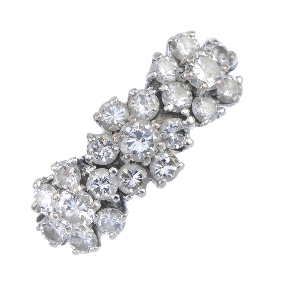 An 18ct gold diamond floral dress ring. The brilliant-cut diamond floral cluster, with similarly-cut