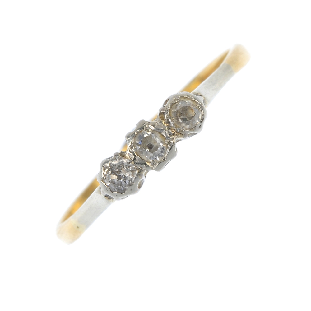 A mid 20th century 18ct gold and platinum diamond three-stone ring. The slightly graduated old-cut