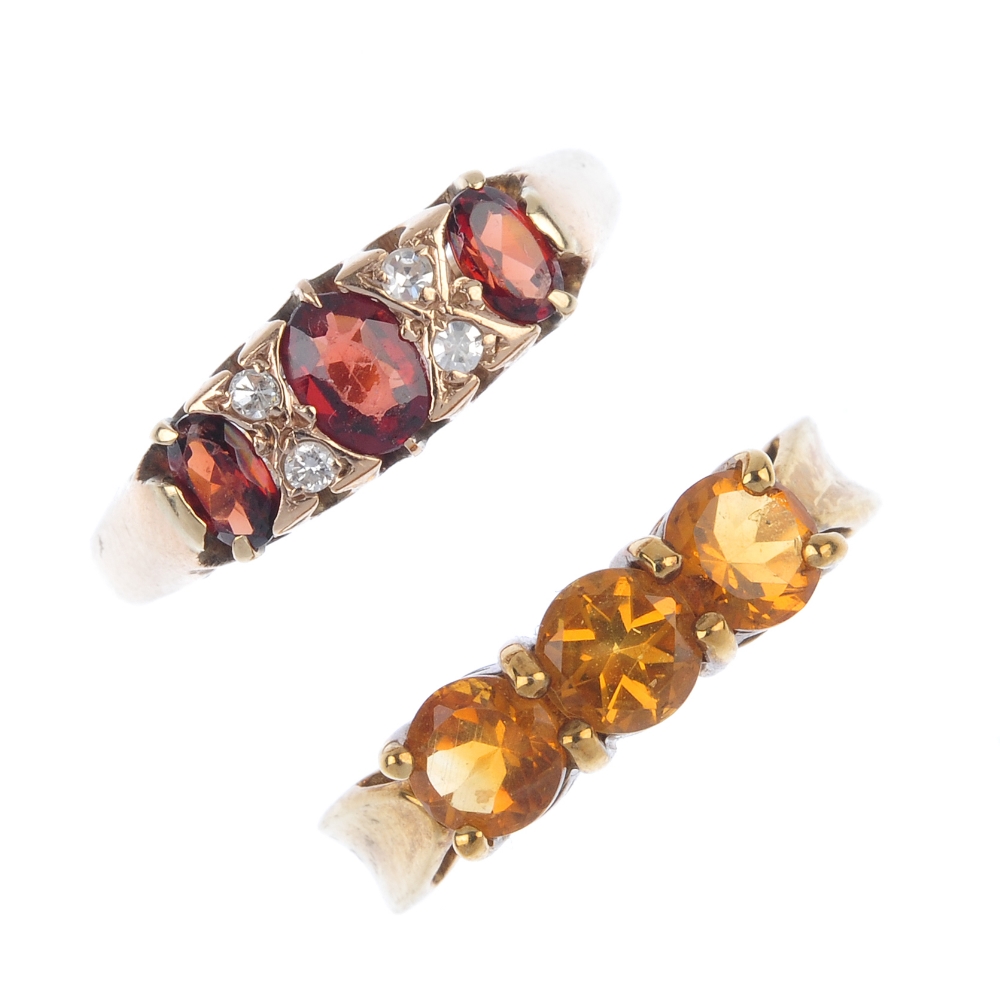A selection of four 9ct gold gem-set rings. To include a garnet and diamond dress ring, an emerald
