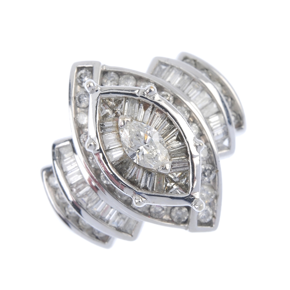 A diamond dress ring. The marquise-shape diamond, within a tapered baguette-cut and square-shape