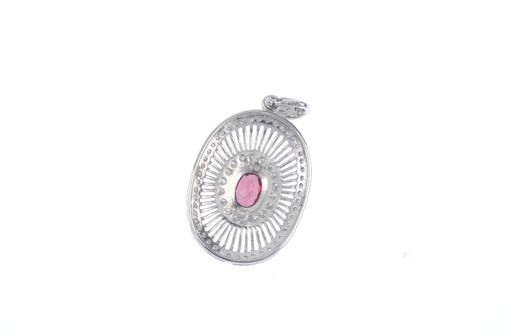 An 18ct gold garnet and diamond pendant. The oval-shape garnet collet, within a brilliant-cut - Image 2 of 2