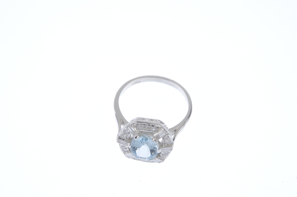 An aquamarine and diamond dress ring. The oval-shape aquamarine, within a single and baguette-cut - Image 2 of 4