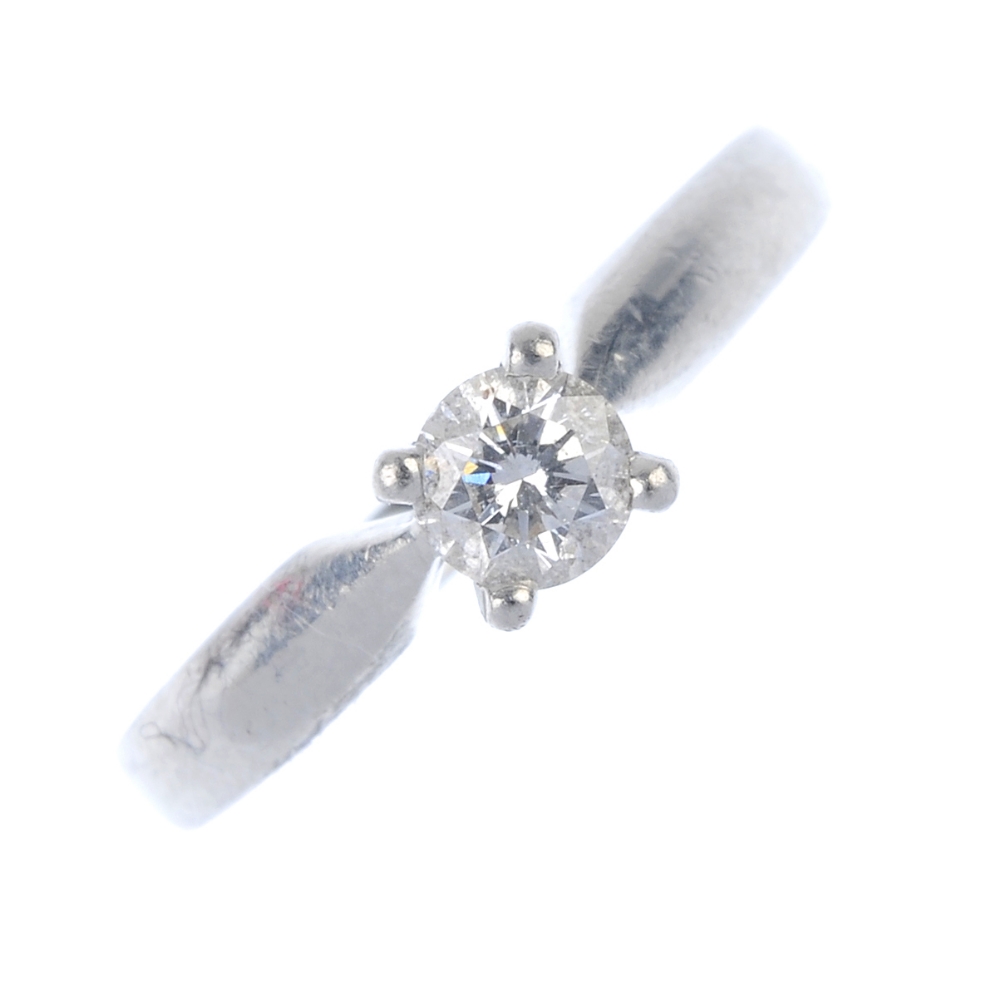 A platinum diamond single-stone ring. The brilliant-cut diamond, to the plain band. Estimated