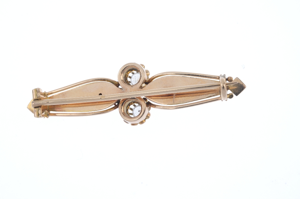 A mid 20th century zircon brooch. The twin circular-shape colourless zircon line, to the stylised - Image 2 of 2