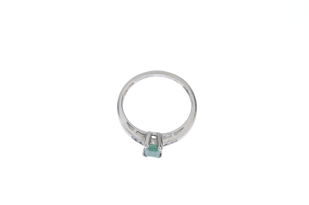 An 18ct gold emerald and diamond dress ring. The rectangular-shape emerald, to the single-cut - Image 2 of 4