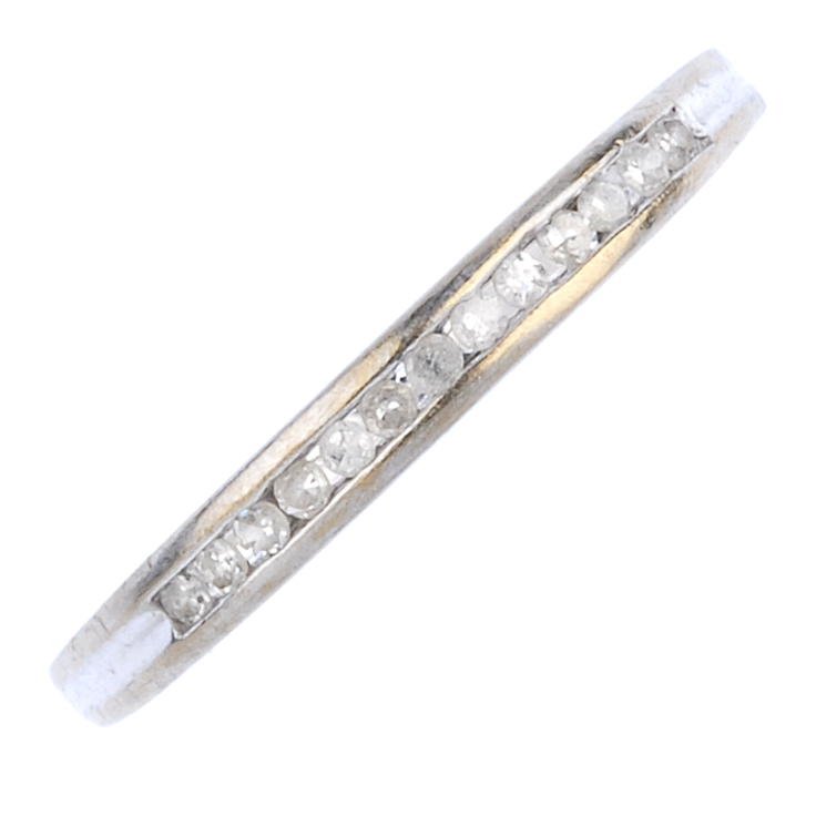 A 9ct gold diamond ring. The single-cut diamond line, inset to the tapered band. Total diamond