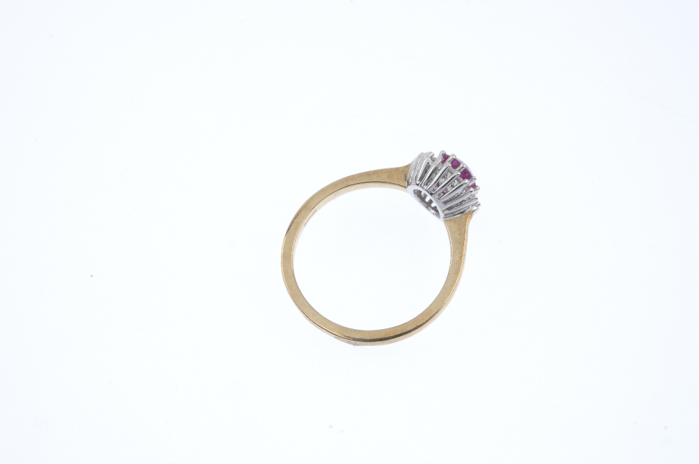A 9ct gold ruby and diamond cluster ring. The oval-shape ruby, within a brilliant-cut diamond - Image 4 of 4
