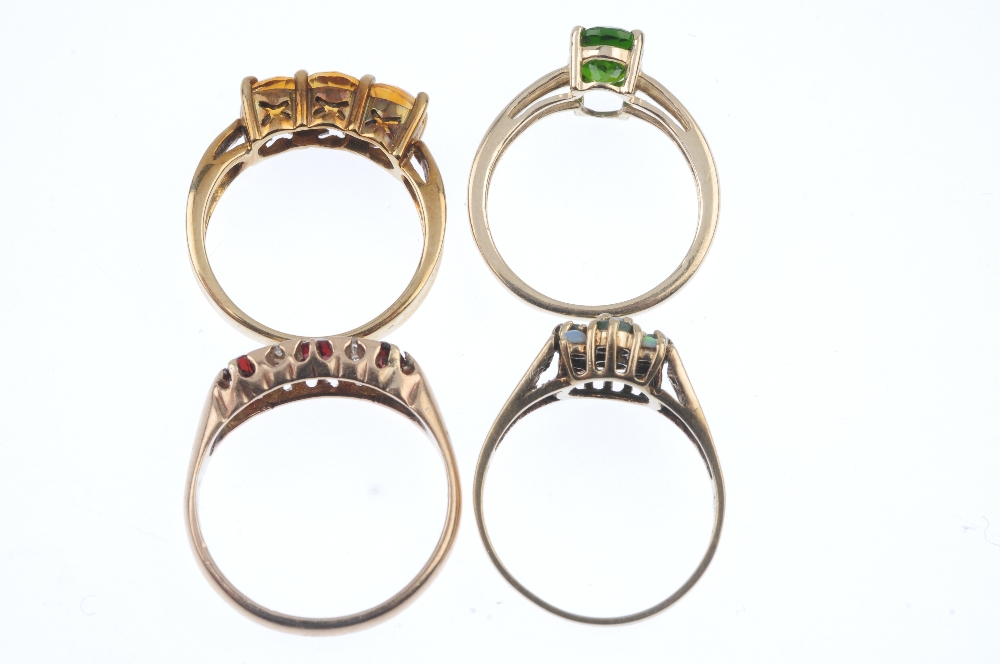 A selection of four 9ct gold gem-set rings. To include a garnet and diamond dress ring, an emerald - Image 3 of 3