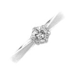 A platinum diamond single-stone ring. The brilliant-cut diamond, to the tapered shoulders and