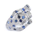 A 9ct gold sapphire and diamond leopard ring. The pave set circular-shape sapphire leopard, with