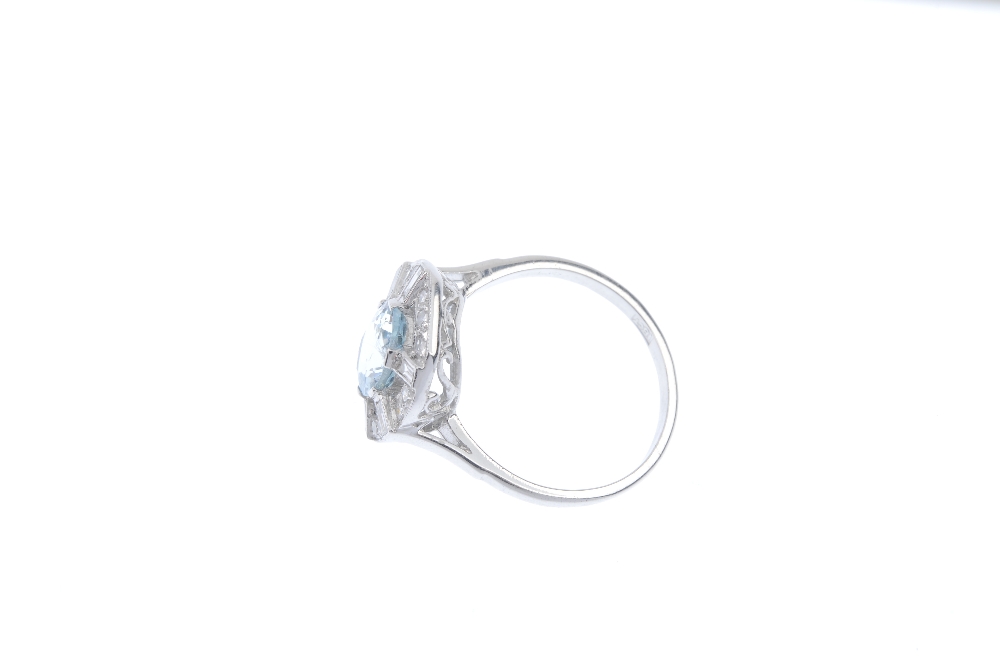 An aquamarine and diamond dress ring. The oval-shape aquamarine, within a single and baguette-cut - Image 3 of 4