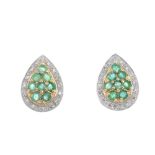 A pair of 9ct gold emerald and diamond cluster ear studs. Each designed as a circular-shape