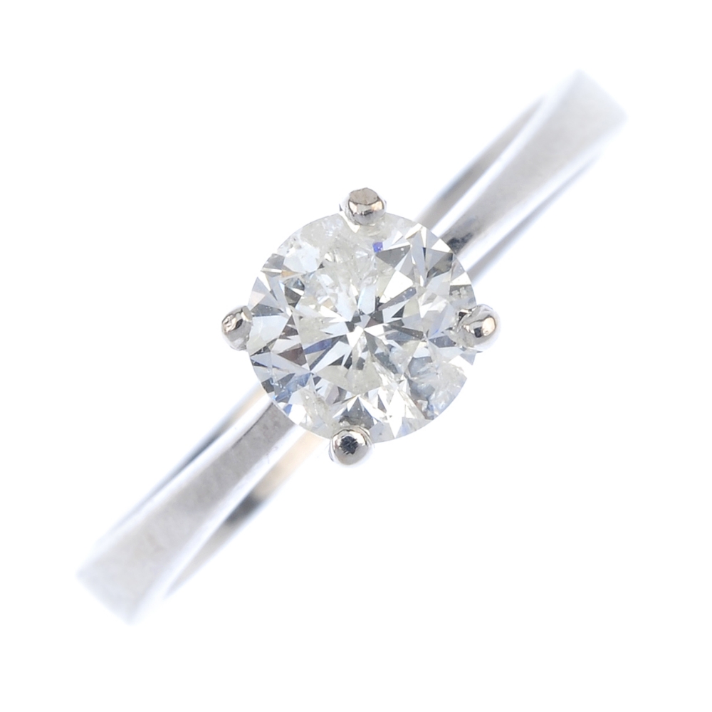 * An 18ct gold diamond single-stone ring. The brilliant-cut diamond, to the tapered shoulders and