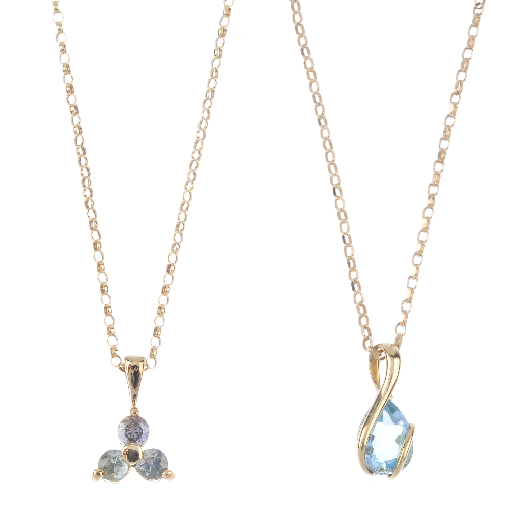 A selection of three pendants. To include a 9ct gold blue topaz pendant, suspended from a 9ct gold