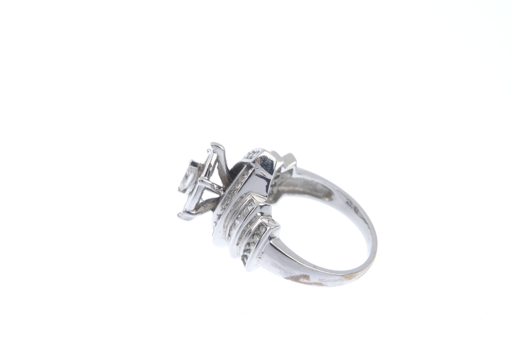 A diamond dress ring. The marquise-shape diamond, within a tapered baguette-cut and square-shape - Image 3 of 4