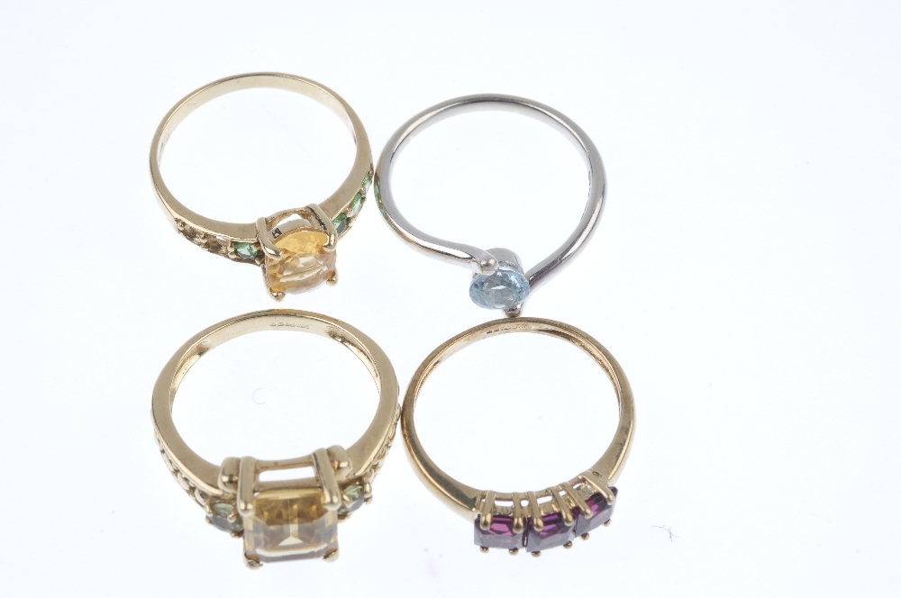 A selection of four 9ct gold gem-set rings. To include a garnet three-stone ring, an aquamarine - Image 2 of 3