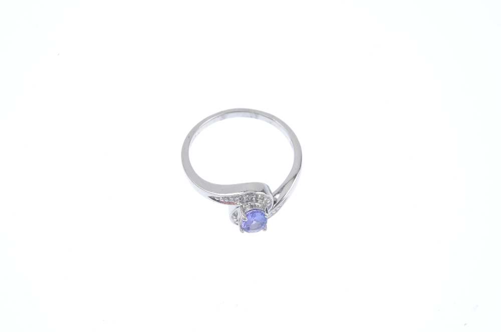 A 9ct gold tanzanite and diamond crossover ring. The oval-shape tanzanite, to the pave-set single- - Image 2 of 4