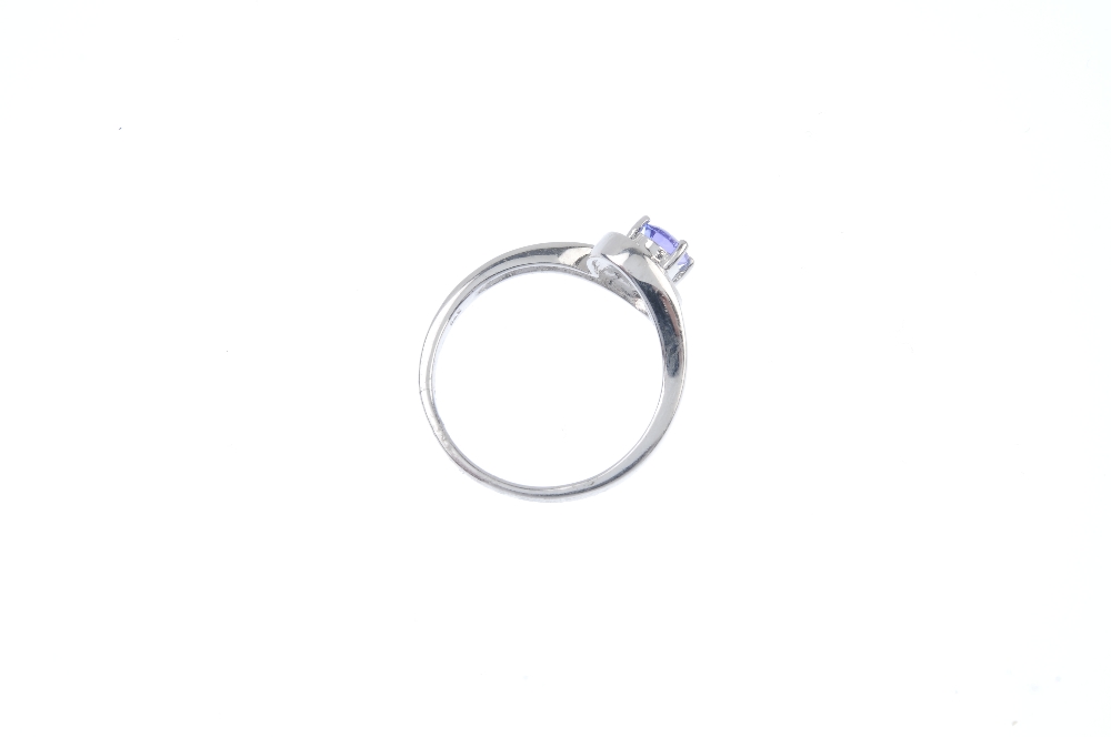 A 9ct gold tanzanite and diamond crossover ring. The oval-shape tanzanite, to the pave-set single- - Image 4 of 4