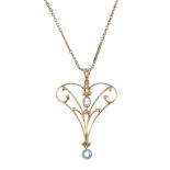 An early 20th century 15ct gold gem-set pendant and 9ct gold chain. The scrolling foliate openwork