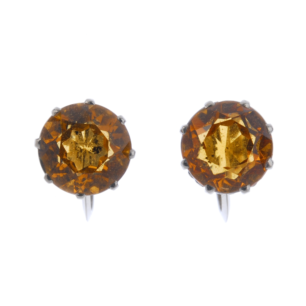 A pair of citrine ear studs. Each designed as a circular-shape citrine, to the screw back fitting.