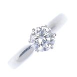 A platinum diamond single-stone ring. The brilliant-cut diamond, weighing 0.68ct, to the tapered