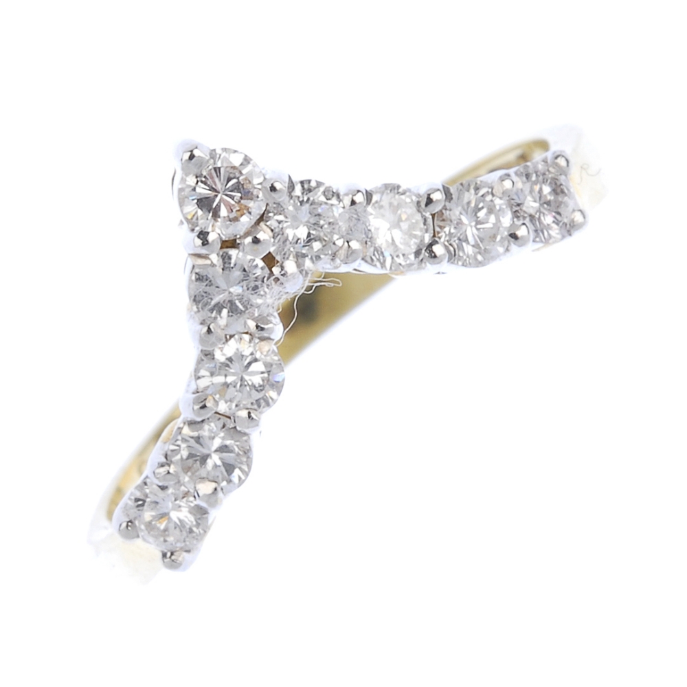 An 18ct gold diamond chevron ring. The brilliant-cut diamond chevron, to the plain band. Estimated