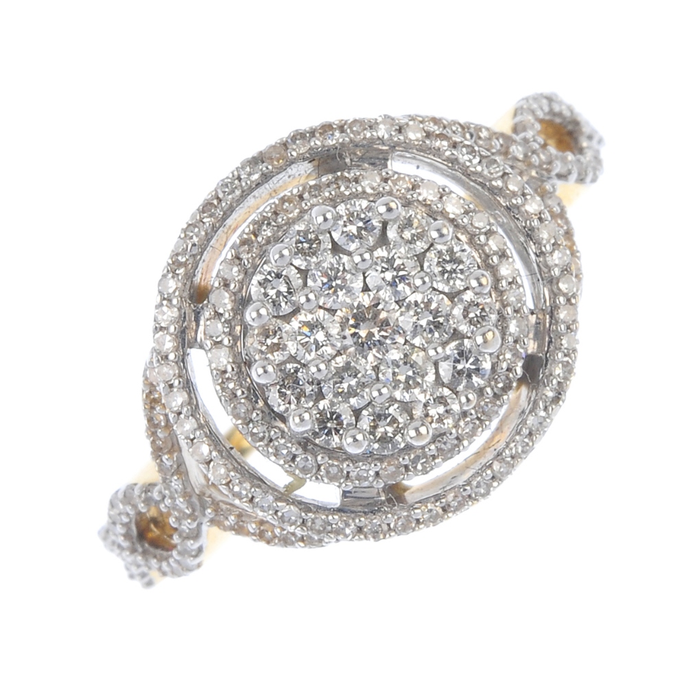 A diamond cluster ring. The pave-set diamond disc, with single-cut diamond double halo and
