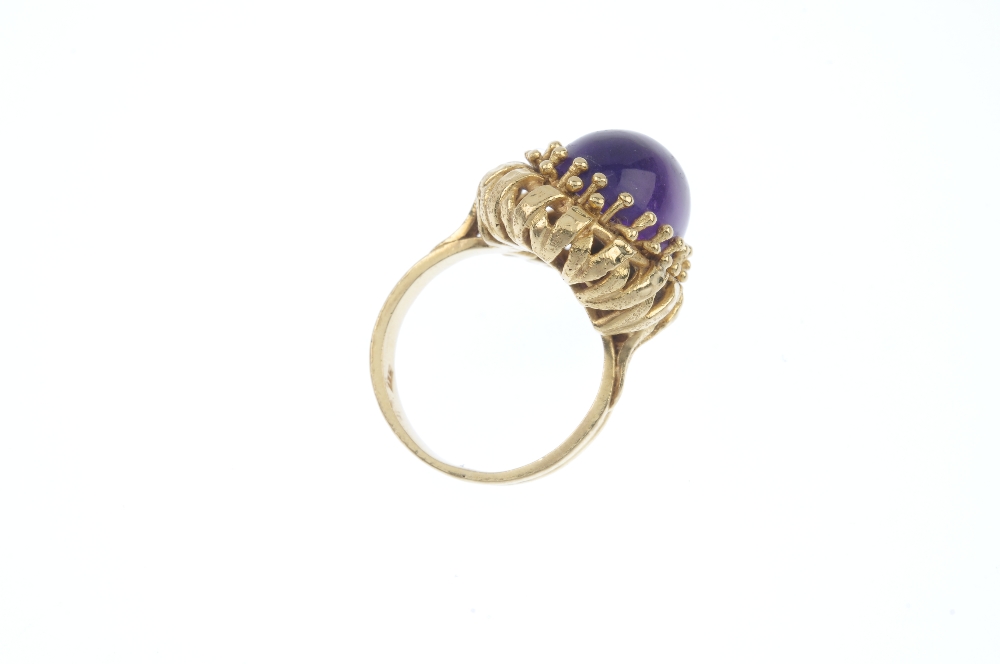 An amethyst single-stone ring. The oval amethyst cabochon, within a bead surround, to the openwork - Image 4 of 4