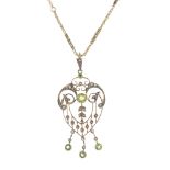 An early 20th century 9ct gold garnet-topped-doublet and split pearl pendant. Of openwork design,